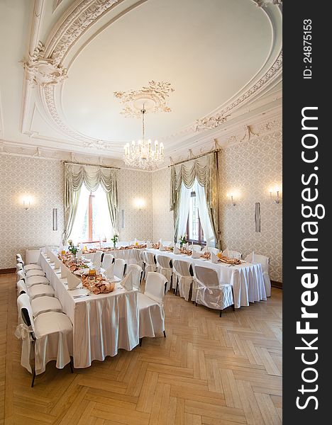 Wedding reception place ready for first guests to come. Beautiful classic white interior