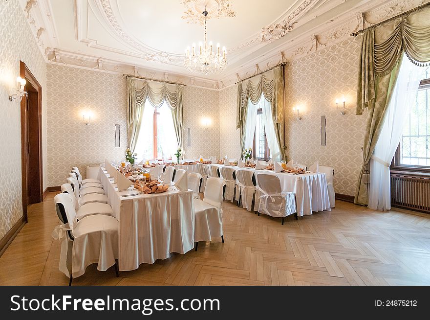 Wedding reception place ready for first guests to come. Beautiful classic white interior