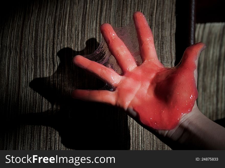 Hand in red slime, during the holiday Halloween, abstract background