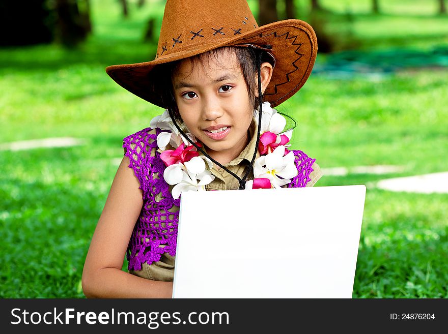 Cute asian girl living with laptop in the park. Cute asian girl living with laptop in the park