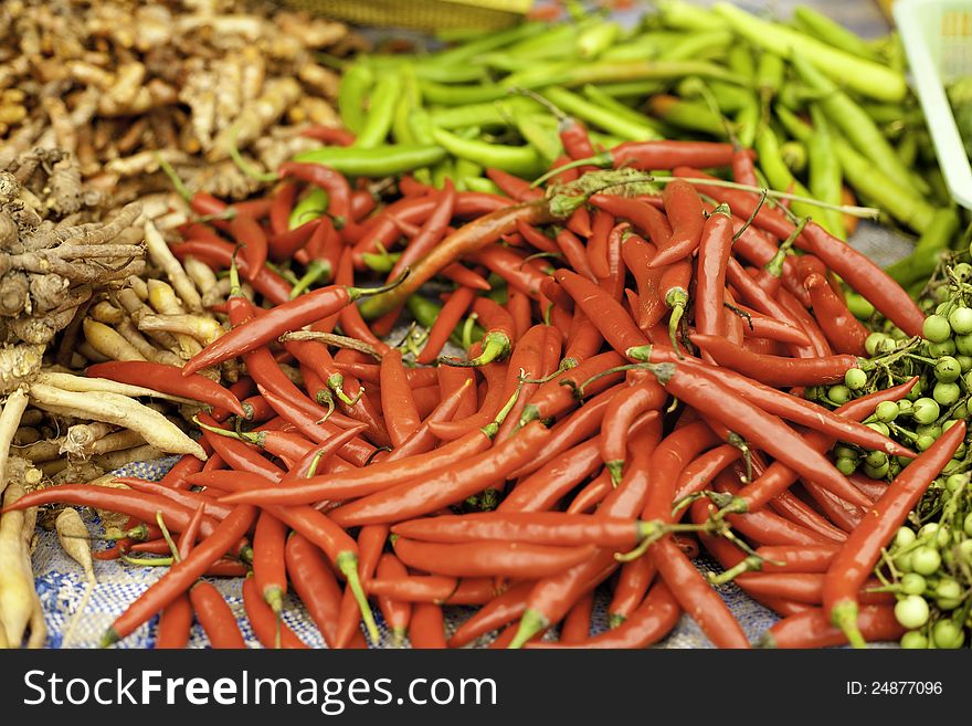 Chillie and spices for cooking. Red chillies in focus with shallow depth for the other chillies in the background. Chillie and spices for cooking. Red chillies in focus with shallow depth for the other chillies in the background.