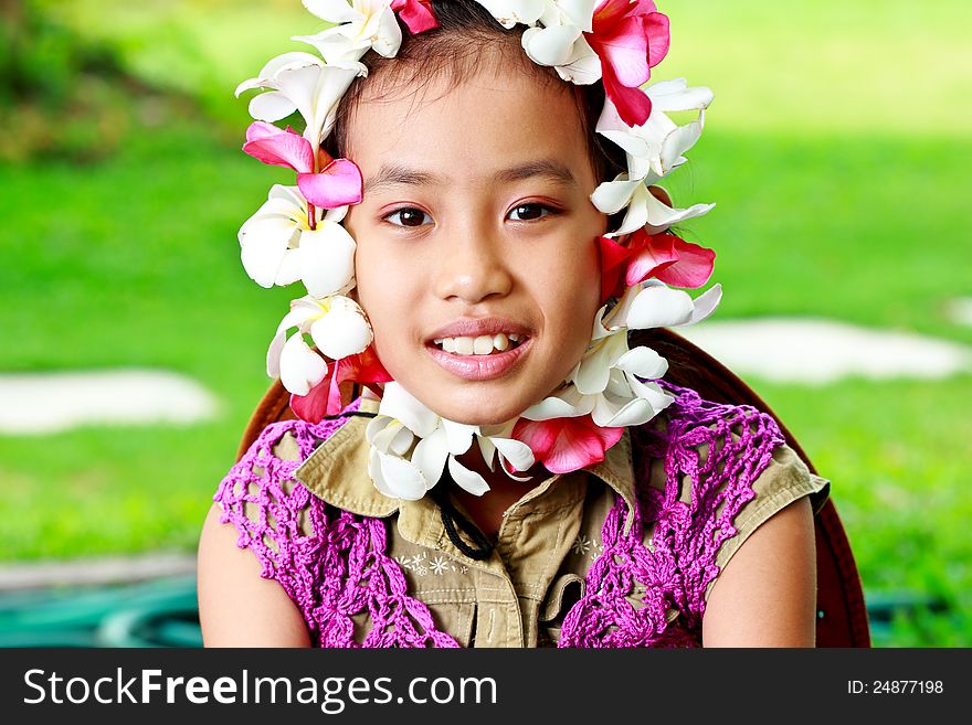 Little girl smiling surrounding a flowers on her face. Little girl smiling surrounding a flowers on her face