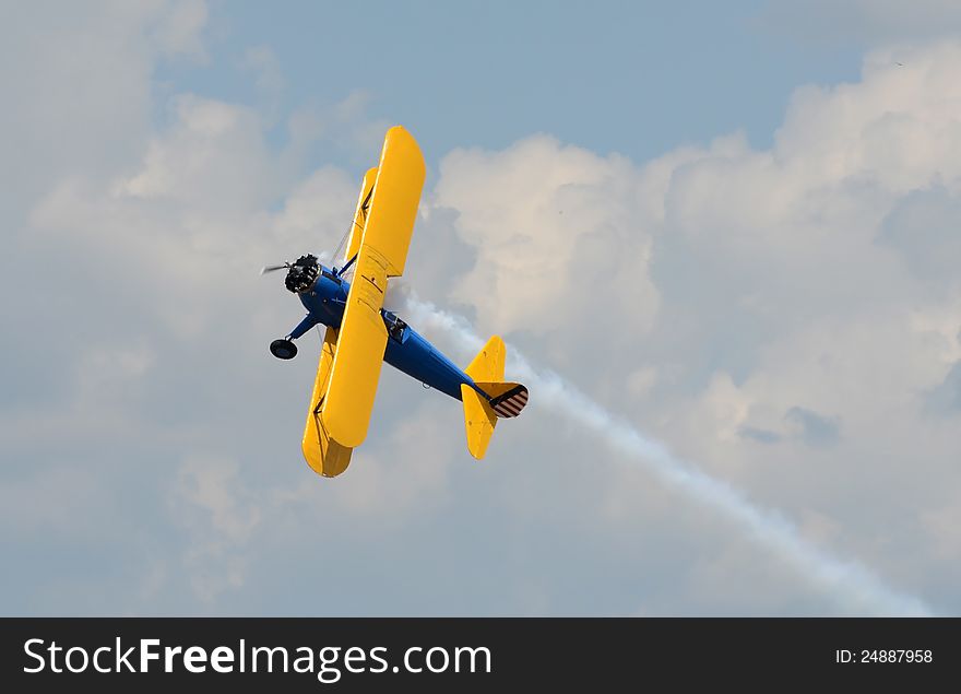 World War II era biplane in yellow color. World War II era biplane in yellow color