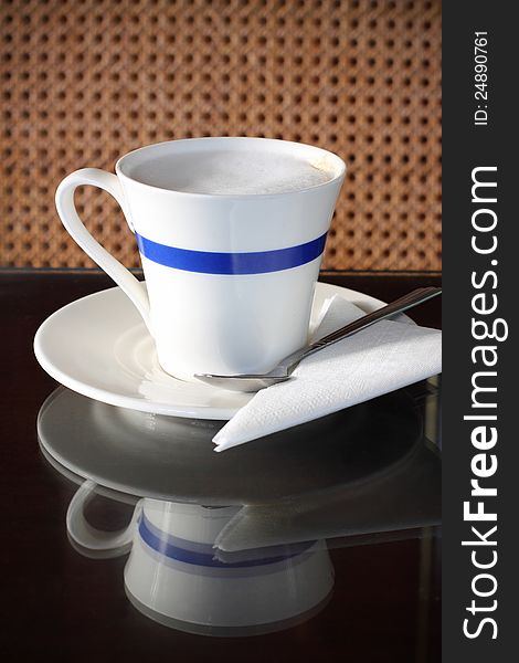 Cup of capuchino coffee on table