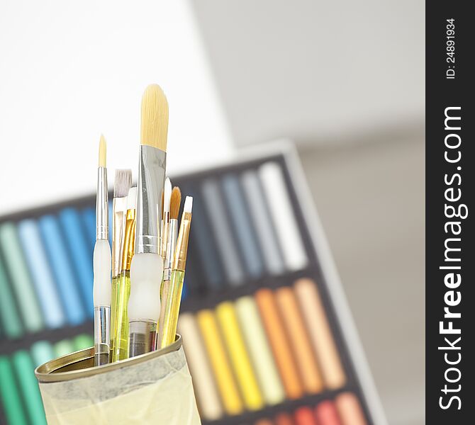 Set of brushes in a can with colorful background