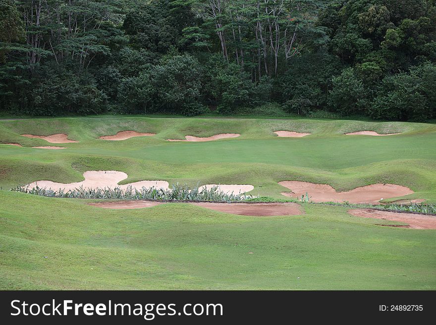 Bunker traps around green at country golf course, Oahu, Hawaii. Bunker traps around green at country golf course, Oahu, Hawaii