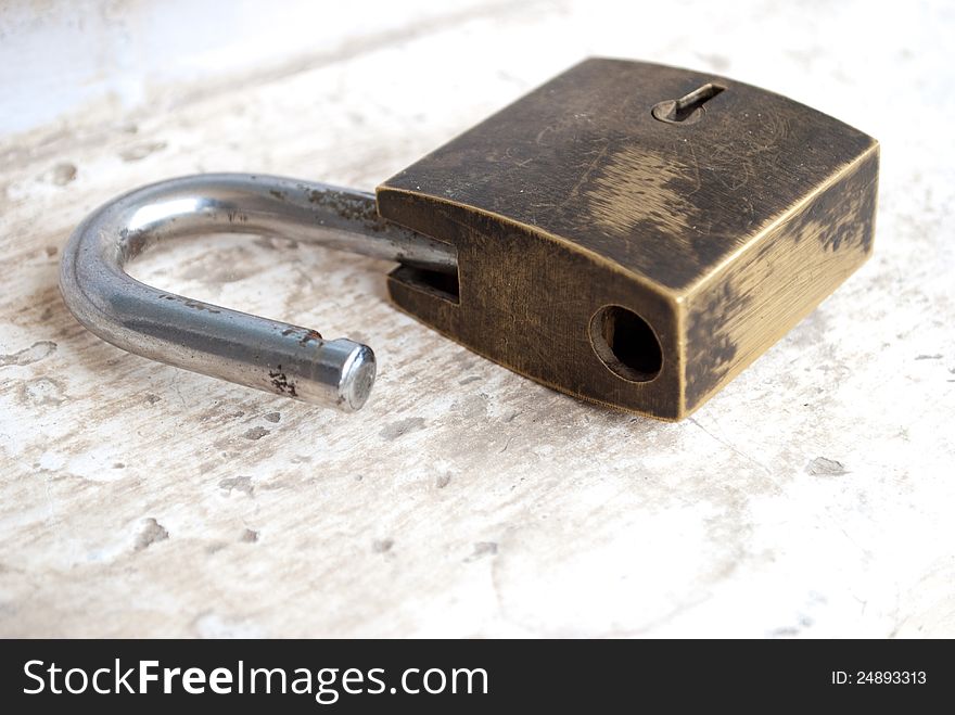 Old metal lock kept on the floor unlocked