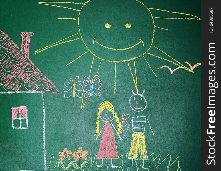 Blackboard with drawing happy couple  with house closeup