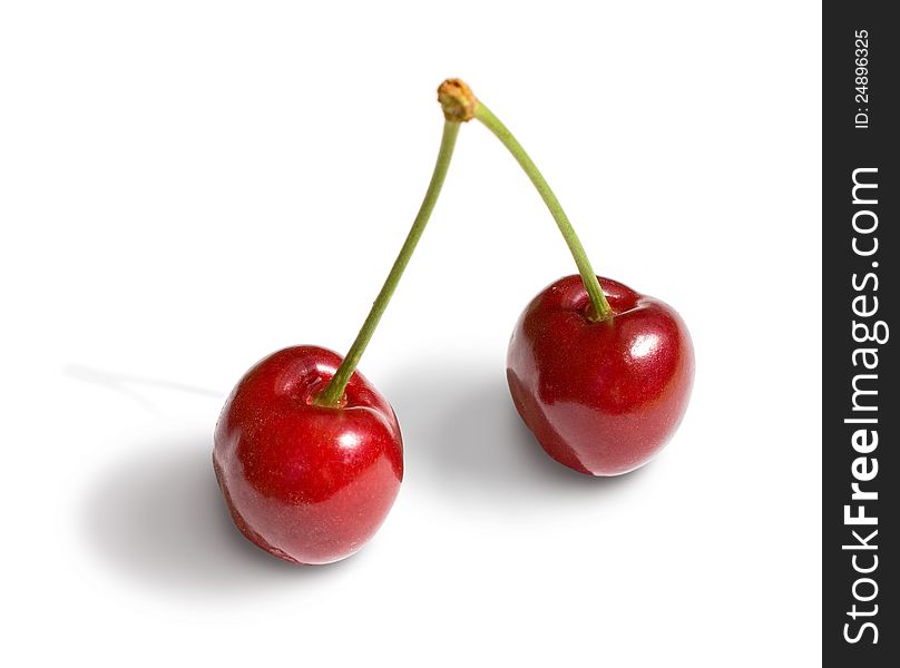 Two cherries close-up on a white background