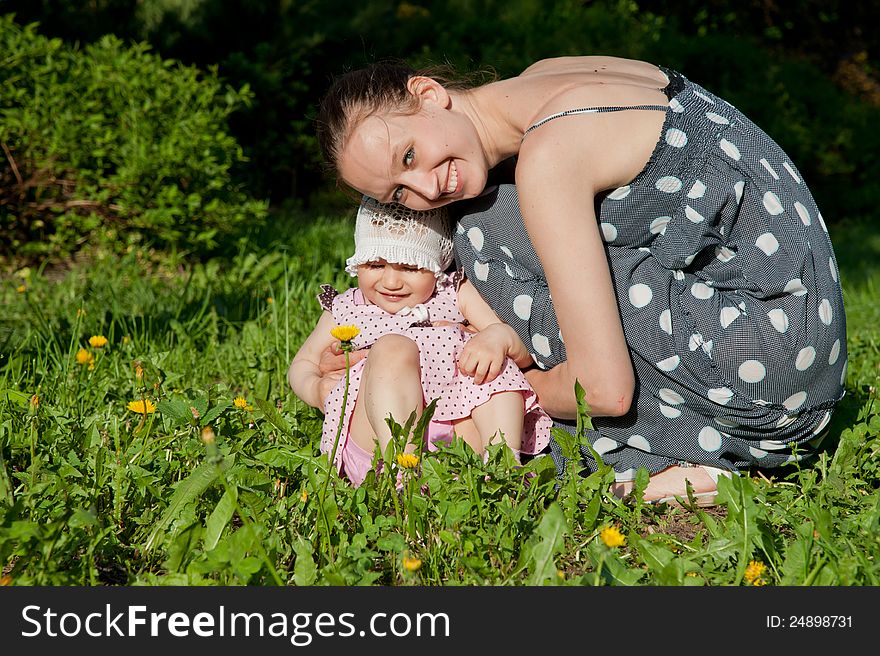 Woman and child sits on the grass