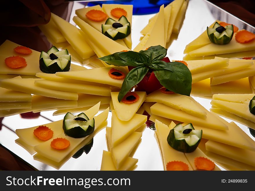 Cheese platter with carrots and cucumber.