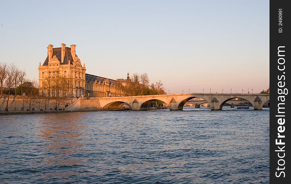 View of the Louvre Museum, across the Seine River, at sunset, Paris, France