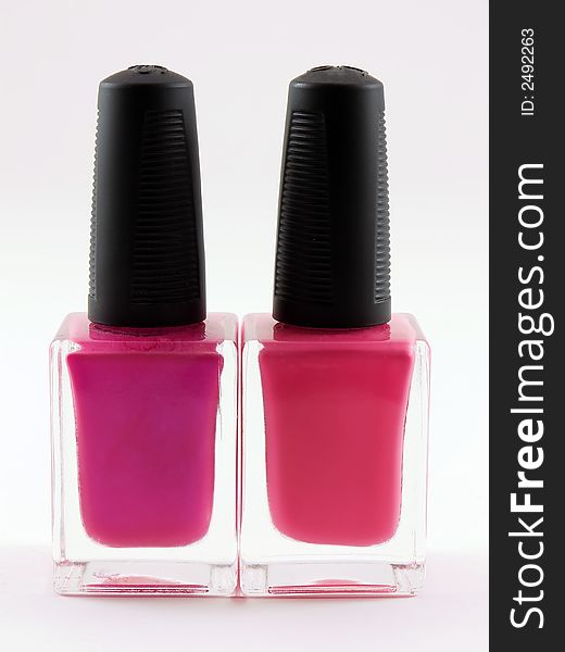 Two bottles of pink nail polish on a white background