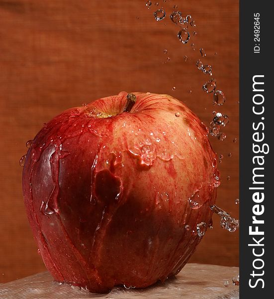 An apple being showered with water