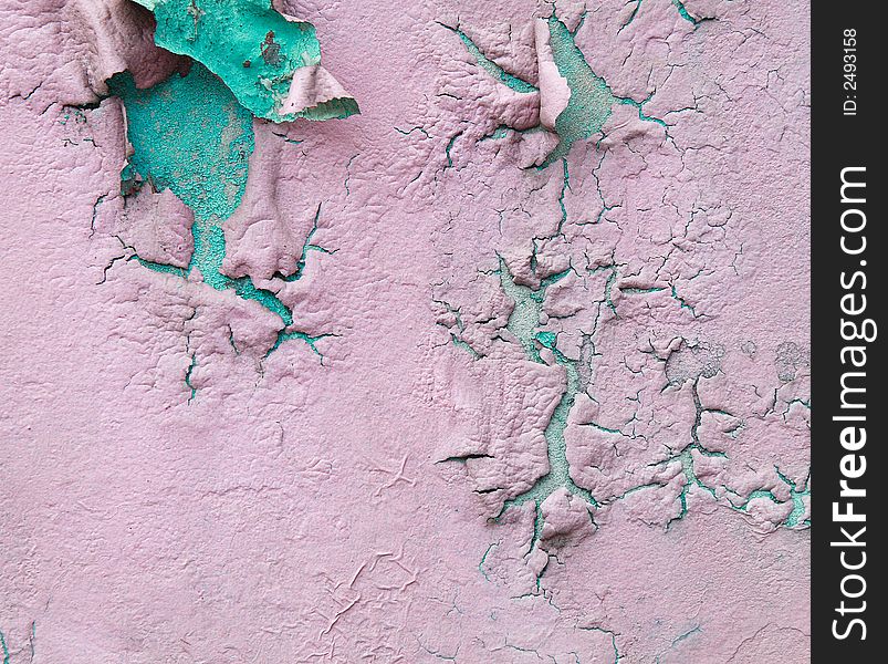 An old wall paint peeling off showing the old paint. An old wall paint peeling off showing the old paint