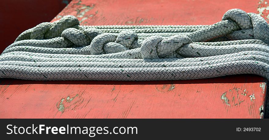 Rope laid across the seat of a plywood boat seat. Rope laid across the seat of a plywood boat seat