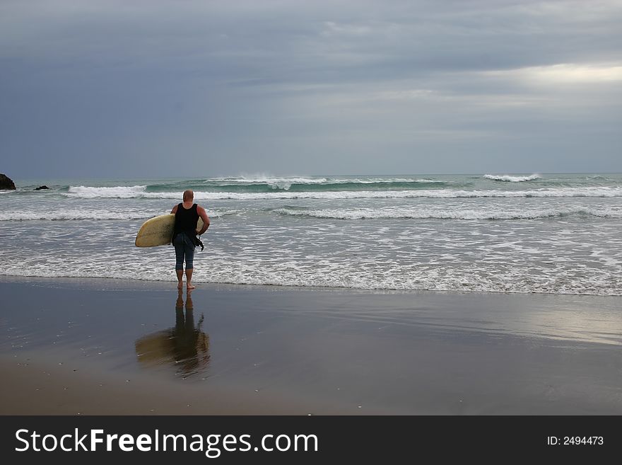 A lone surfer checking to see what the weather is like