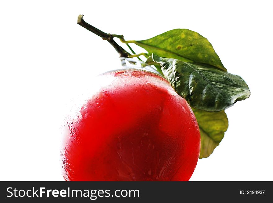 An isolated view of the bottom of a fresh strawberry drink with leaves on the side of the glass as garnish.