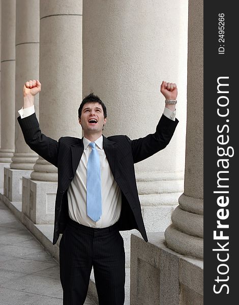 Young businessman throws his arms up in a gesture of success. Young businessman throws his arms up in a gesture of success.