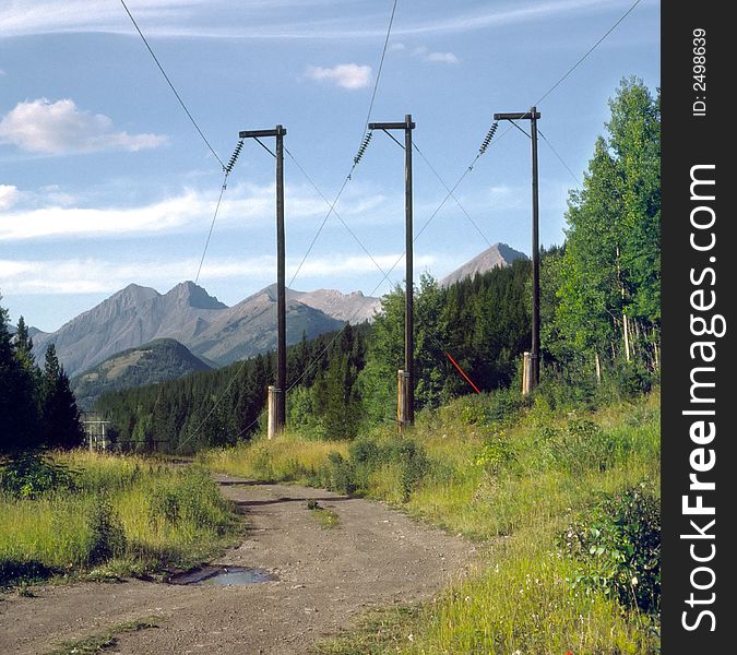 Power transmission line and service road support a mining town in the Elk River valley, Rocky Mountains, Canada. Power transmission line and service road support a mining town in the Elk River valley, Rocky Mountains, Canada.