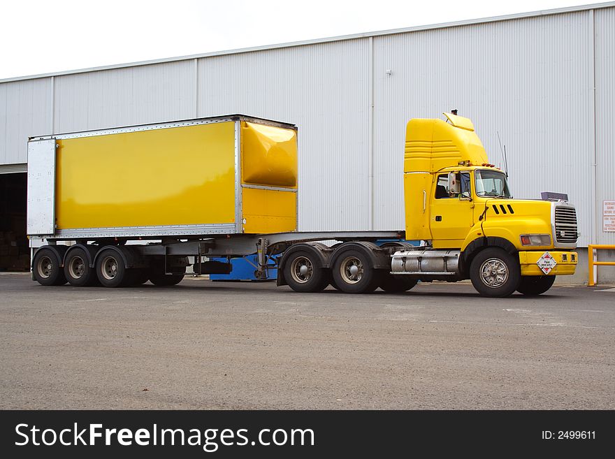 Articulated yellow semi cargo truck. Articulated yellow semi cargo truck