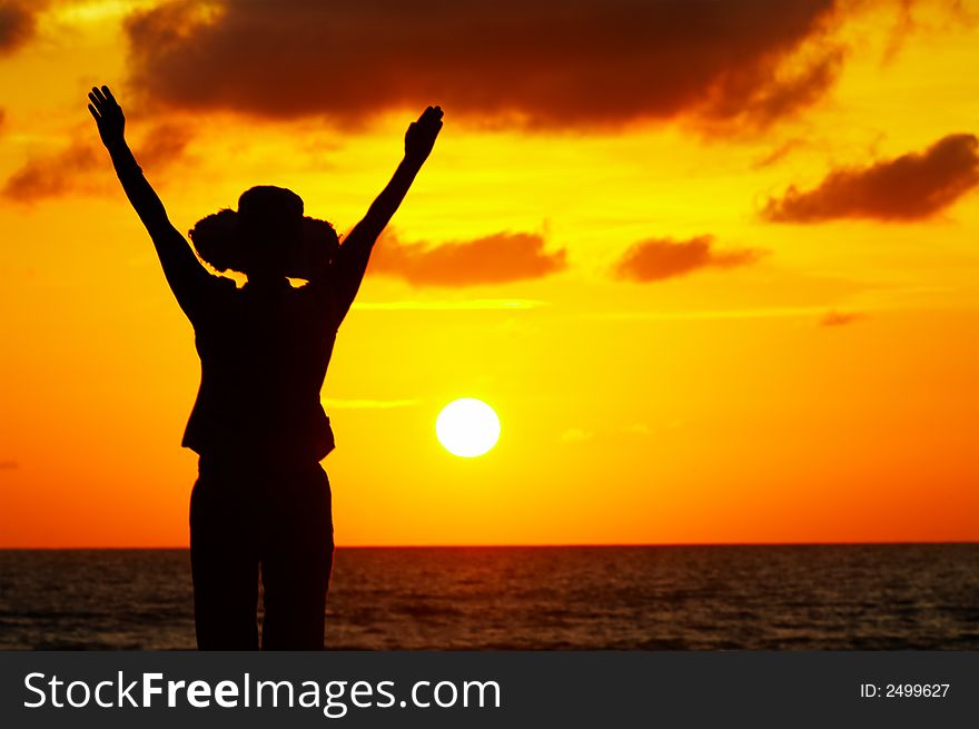 Silhouette of a woman on the beach during sunset. Silhouette of a woman on the beach during sunset