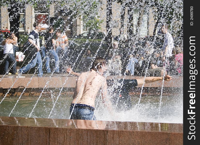 Two boys are playing in a fountain. Two boys are playing in a fountain.