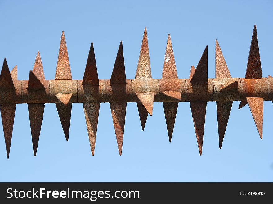 Rusty spikes on a fence. Rusty spikes on a fence