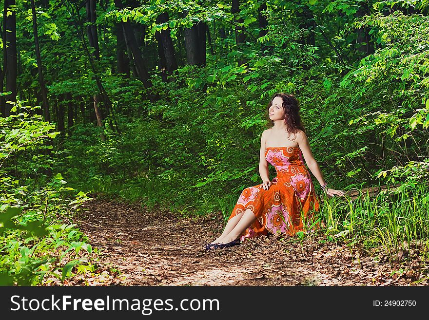 Young woman sitting in forest