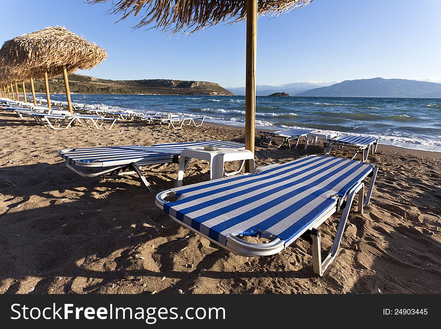 Empty sandy beach with a row of chairs. Empty sandy beach with a row of chairs