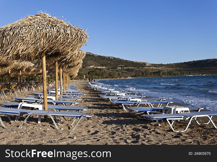 Empty sandy beach with a row of chairs. Empty sandy beach with a row of chairs
