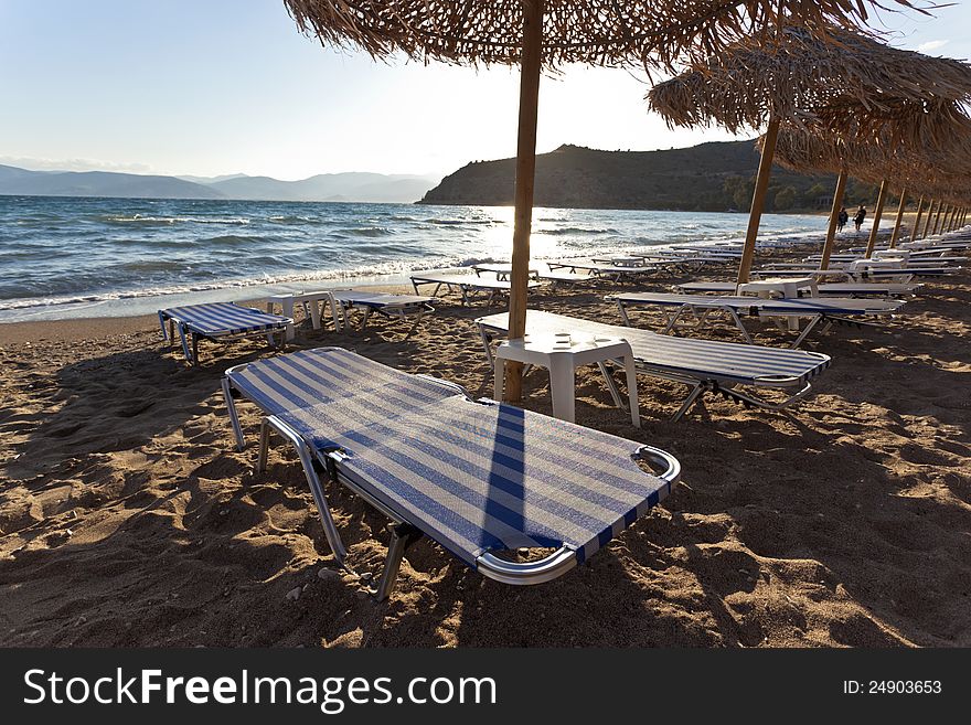 Empty sandy beach with a row of chairs. Empty sandy beach with a row of chairs