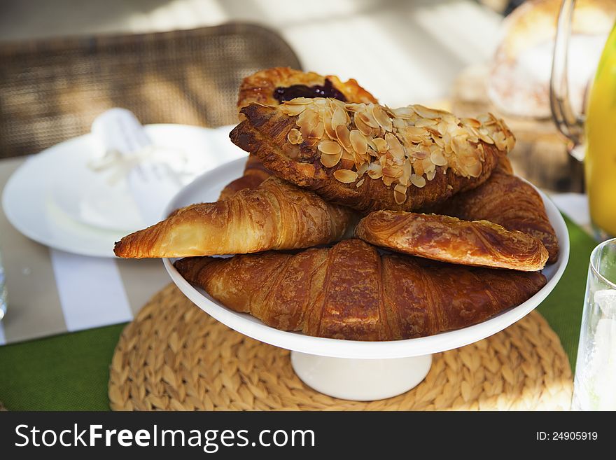 Fresh croissants on outdoor table setting. Fresh croissants on outdoor table setting