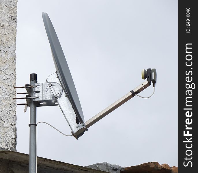 Dish of parabolic aerial on a roof