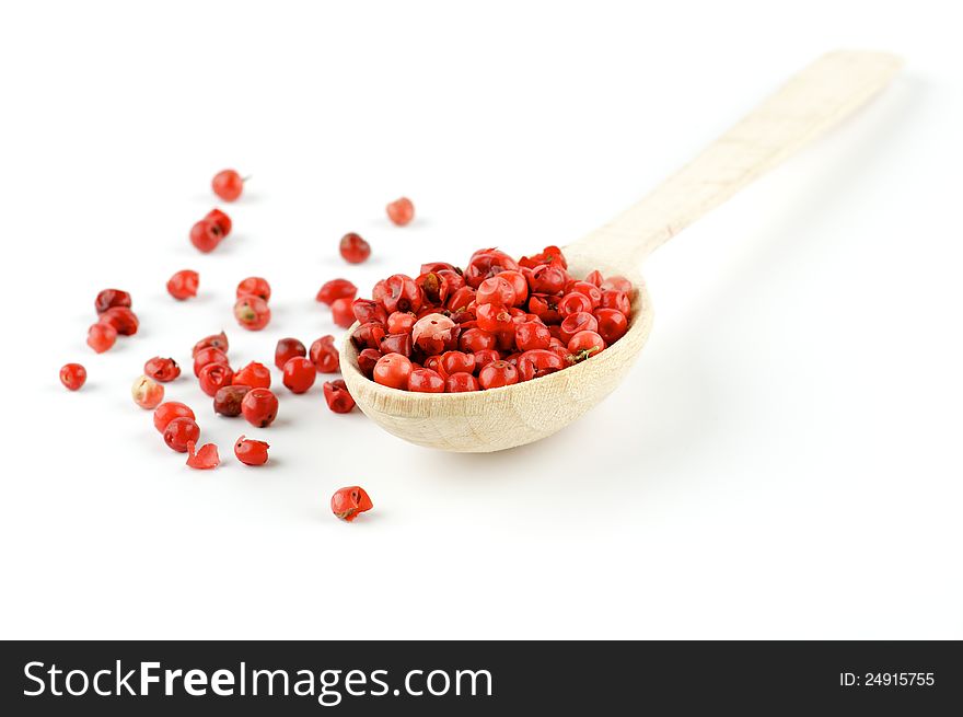 Red pepper in wooden spoon  on white background