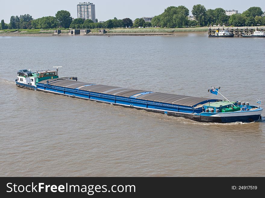 Big barge on scheldt river in antwerp, Belgium. A car on it. Big barge on scheldt river in antwerp, Belgium. A car on it.