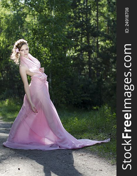 Young girl in pink dress at forest. Young girl in pink dress at forest