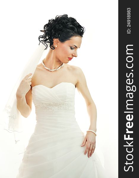 Portrait of a beautiful woman dressed as a bride. on white background