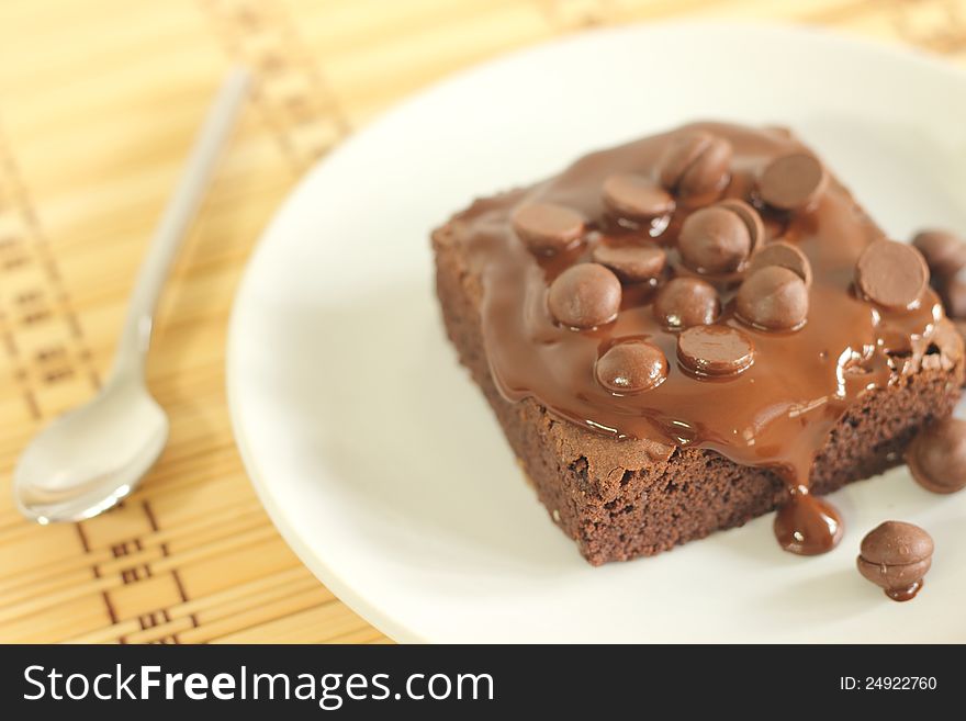 The chocolate cake with  spoon and coffeecup