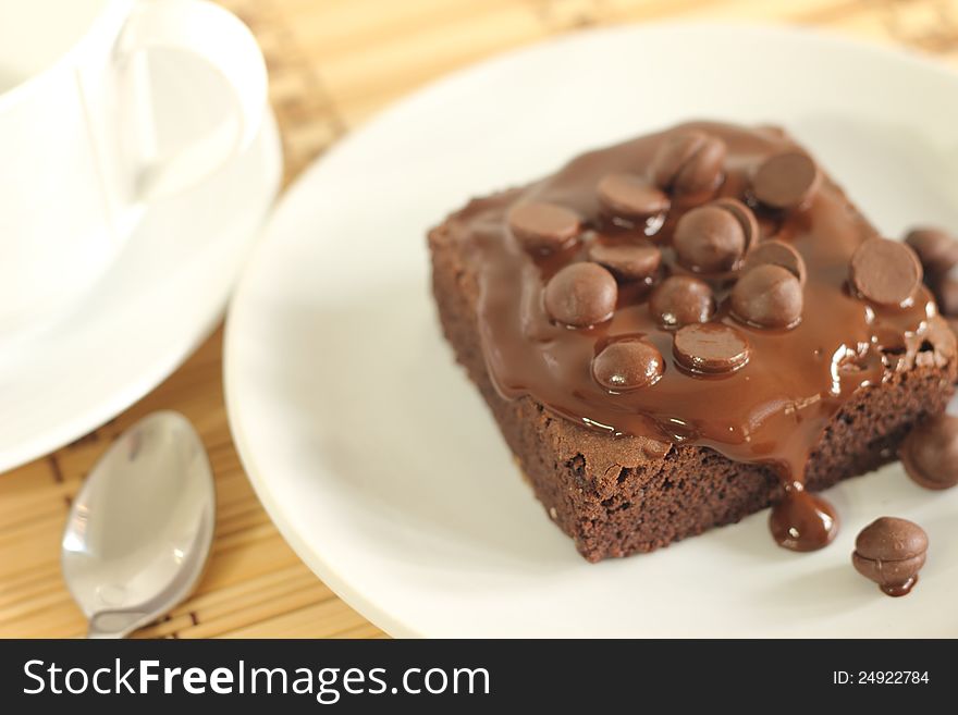 Chocolate cake and spoon and coffee cup. Chocolate cake and spoon and coffee cup