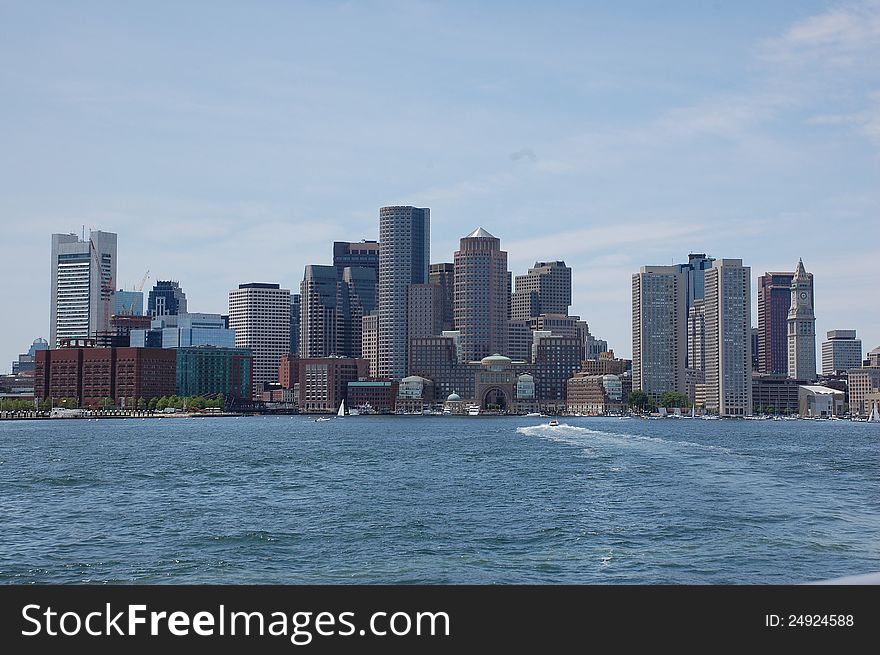 Boston skyline as seen from a boat sailing into the harbor