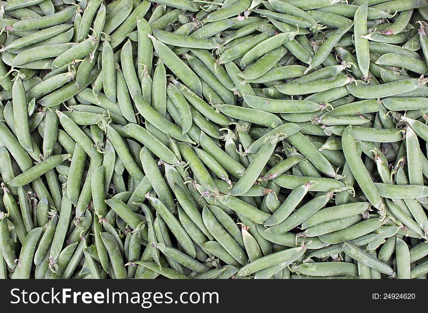 Pea pods for the preparation of meals at a market stand.