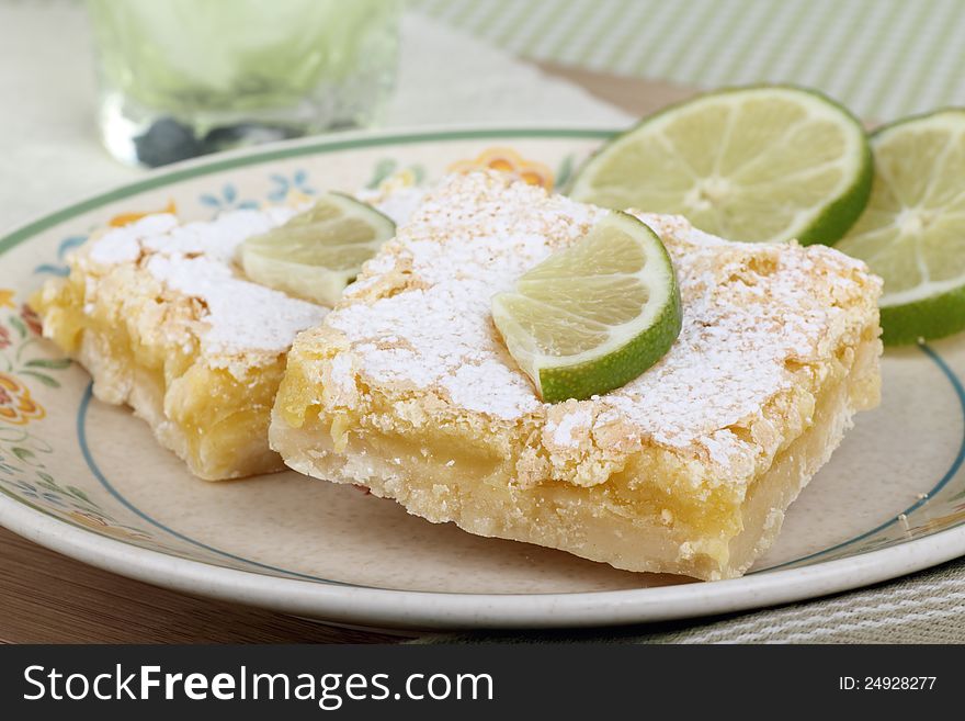 Lime bars with lime slices on a plate. Lime bars with lime slices on a plate
