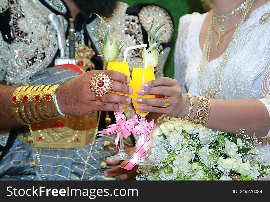 A married couple holding a drink in their hands