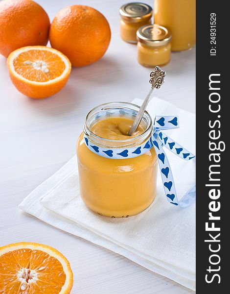 Passionfruit cream in a jar with oranges