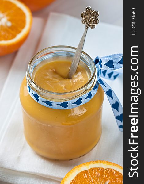 Passionfruit cream in a jar with oranges