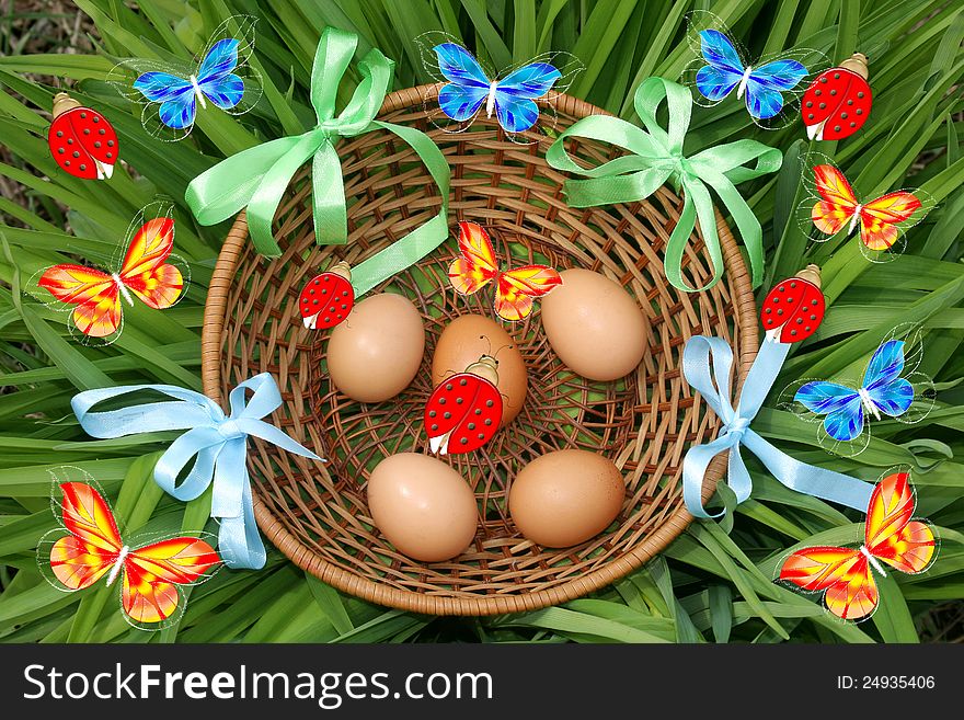 Beautiful basket of Easter eggs on a green grass. Easter