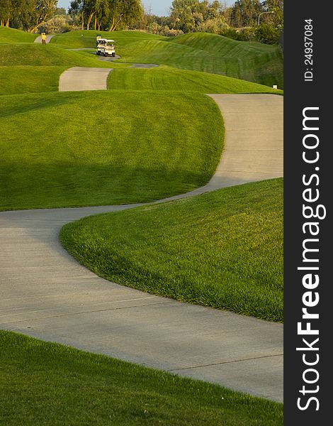 In The Fairway Golf Carts Make Way Down Ninth Hole