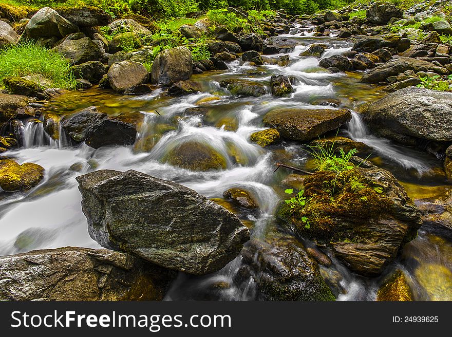 Picture a mountain river flowing among stones