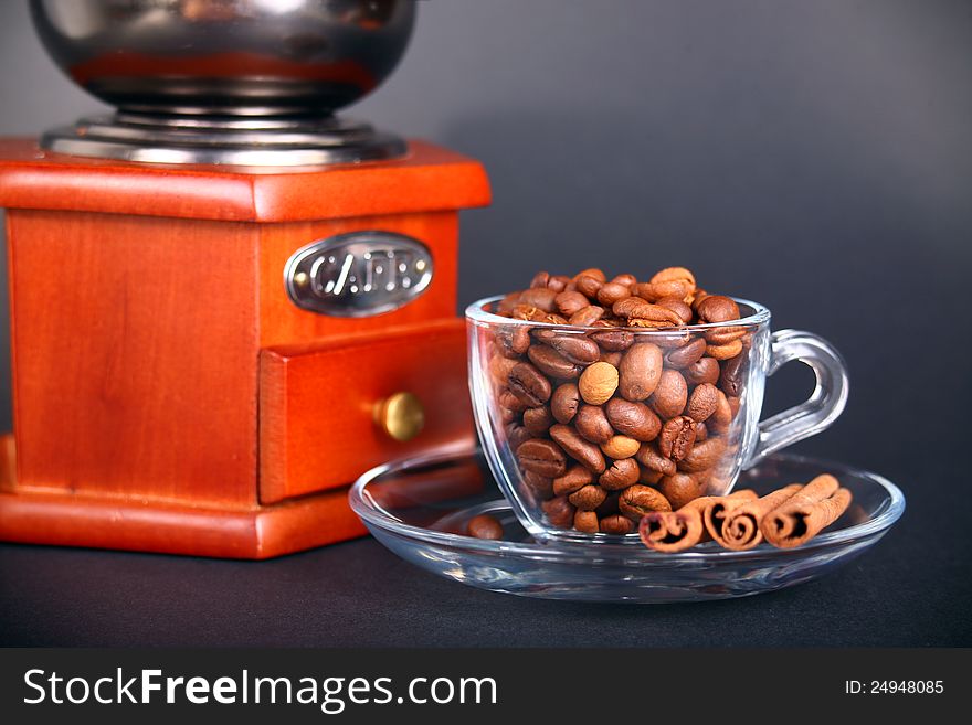 Vintage coffee grinder with a cup of beans. Vintage coffee grinder with a cup of beans